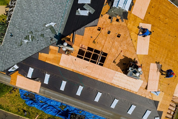 aerial view of house with shingles being replaced